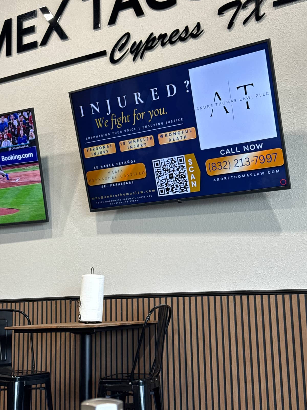 A personal injury law firm advertisement playing on a screen at Mex Taco House
